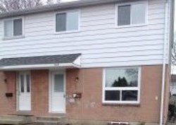 Cardiff Acres - townhouse with brown bricks and white siding